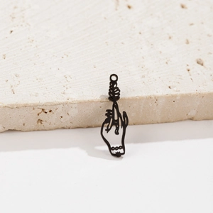 Detail of gothic black metal hand holding flower pendant charm for DIY jewelry making