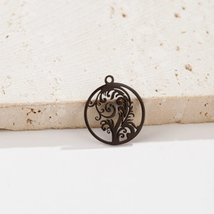 Detailed close-up of a black stainless steel cutout pendant featuring a tree of life design