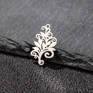 Detailed macro view of bohemian tree of life pendant on natural grey stone background