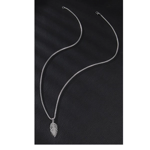 Minimalist stainless steel feather pendant necklace on black textured leather background