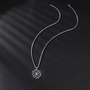 Silver hollow flower pendant necklace in minimalist stainless steel on black leather