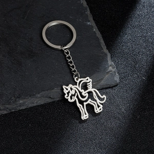 Silver stainless steel unicorn keychain with hollow design on black stone background