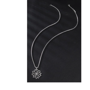 Hollow daisy pendant necklace in stainless steel on black leather background
