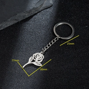Silver stainless steel rose flower pendant keychain with dimensions 17x30mm on black surface