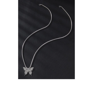 Minimalist butterfly pendant necklace in silver stainless steel on dark leather backdrop