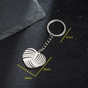 Polished stainless steel heart keychain with geometric rotating texture and ring