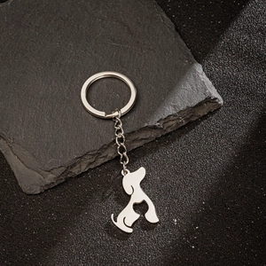 Minimalist stainless steel dog silhouette keychain with bone cutout on black stone