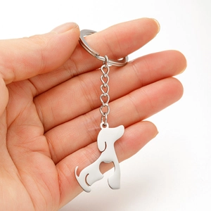 Silver stainless steel dachshund dog keychain with heart cutout shown on a hand