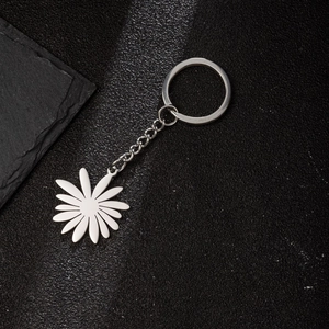 Detail shot of silver daisy flower pendant on stainless steel keychain with metal ring