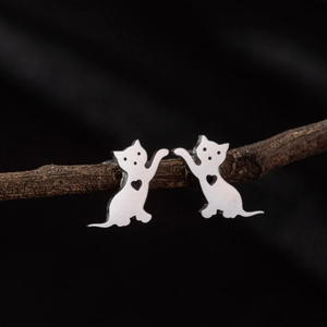Boucles d'oreilles chat en acier inoxydable avec cœur ajouré sur fond noir élégant