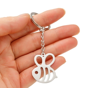 Polished stainless steel bee charm keychain with hollow wings held in hand
