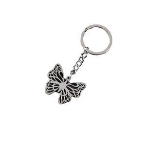 Minimalist stainless steel butterfly keychain with intricate cutout design on white backdrop