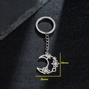 Minimalist silver stainless steel crescent moon keychain with hollow floral pattern