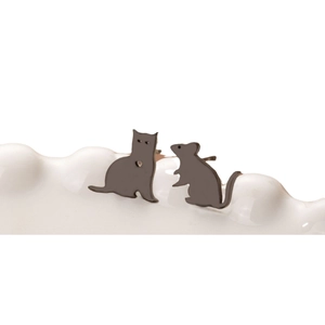 Asymmetric stainless steel cat and mouse stud earrings on a white wavy display stand