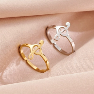 Minimalist musical note open ring in gold and silver finish with silk background