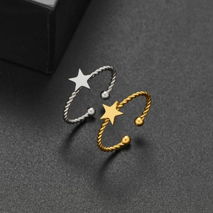 Minimalist stainless steel star rings in gold and silver with twisted band design