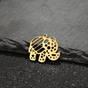Bohemian gold elephant charm made of stainless steel on black stone background