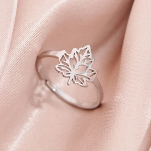 Adjustable silver maple leaf ring with hollow-out design on elegant satin background