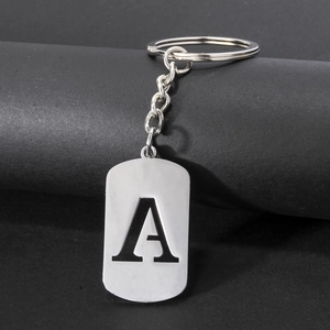 Detailed macro view of polished stainless steel keychain featuring engraved letter A pendant