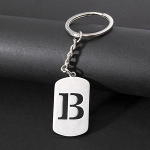 Close-up of a polished stainless steel keychain with an engraved letter B pendant