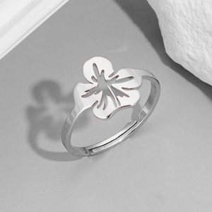 Adjustable hollow flower ring in silver stainless steel on a minimalist grey background
