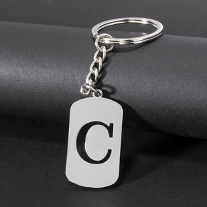 Polished stainless steel keychain with hollow letter C pendant on a dark background