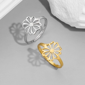 Macro detail of adjustable stainless steel flower rings in gold and silver finishes