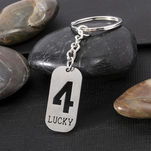 Detailed macro of silver stainless steel keychain with hollow number 4 and LUCKY engraving