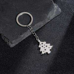 Polished silver stainless steel Christmas tree keychain with star cutouts on rock