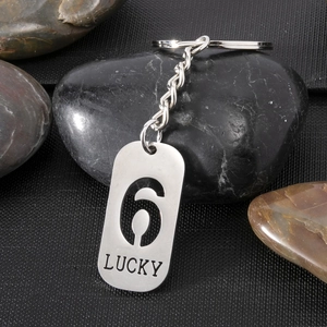Detail of silver stainless steel keychain with lucky number 6 and LUCKY engraving