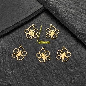 Golden 20mm hollow leaf charms in stainless steel displayed on a black stone surface