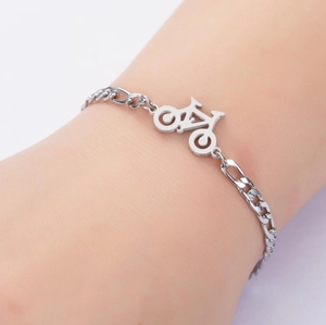 Detailed view of bicycle charm bracelet with stainless steel curb chain on wrist