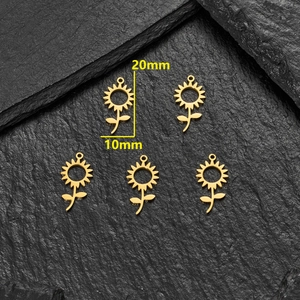 5pcs set of 18K gold plated stainless steel sunflower pendants on a black slate background