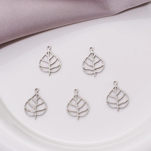 Macro shot of five silver stainless steel hollow leaf pendants for DIY jewelry making