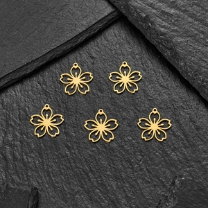 Detailed macro view of five 18K gold-plated stainless steel cherry blossom flower pendants