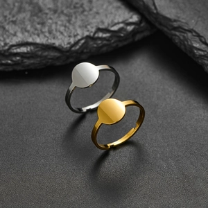 Minimalist stainless steel open rings in gold and silver finish on rock background