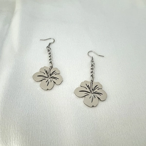 Macro detail of silver petal earrings with fine chain and five-petal floral drop charms