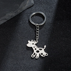 Polished stainless steel giraffe pendant keychain on a minimalist black stone background