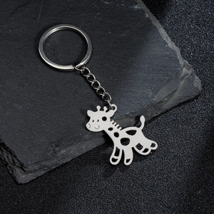 Polished stainless steel giraffe pendant keychain on a stylish dark stone background