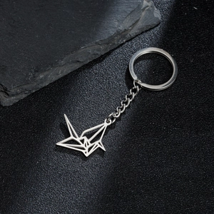 Polished silver stainless steel origami crane keychain with hollow geometric design