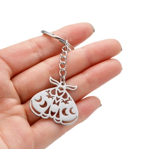 Sleek stainless steel moth keychain with hollow crescent moon and star patterns