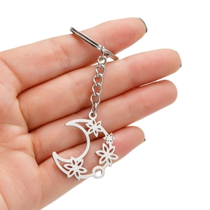 Handheld silver stainless steel keychain featuring a hollow moon and floral cutout design