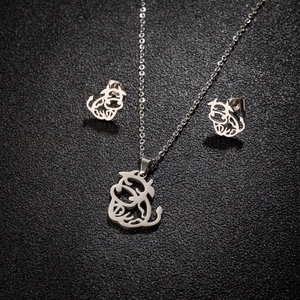 Minimalist stainless steel jewelry set featuring a cute hollow cow pendant and matching studs
