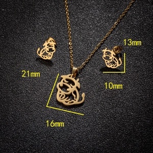 Golden stainless steel ox jewelry set with necklace and stud earrings on dark background