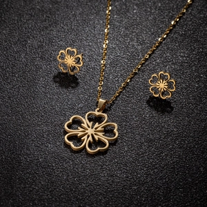 Detailed view of 18K gold plated hollow cherry blossom necklace and earrings set