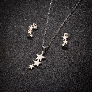Silver cascading star jewelry set featuring a necklace and stud earrings in 18K gold finish