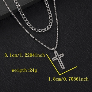 Detail view of double layer gothic cross pendant necklace with silver cuban chain