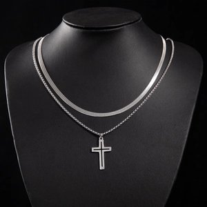 Detail of silver double layered gothic cross pendant on snake and link chain for men