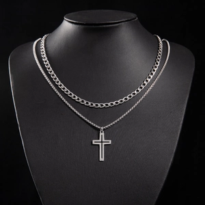 Detail of silver double-layered gothic necklace with cross pendant on neck mannequin