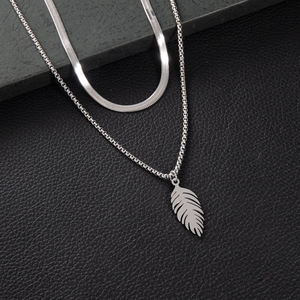 Double-layer stainless steel necklace featuring a snake chain and feather pendant